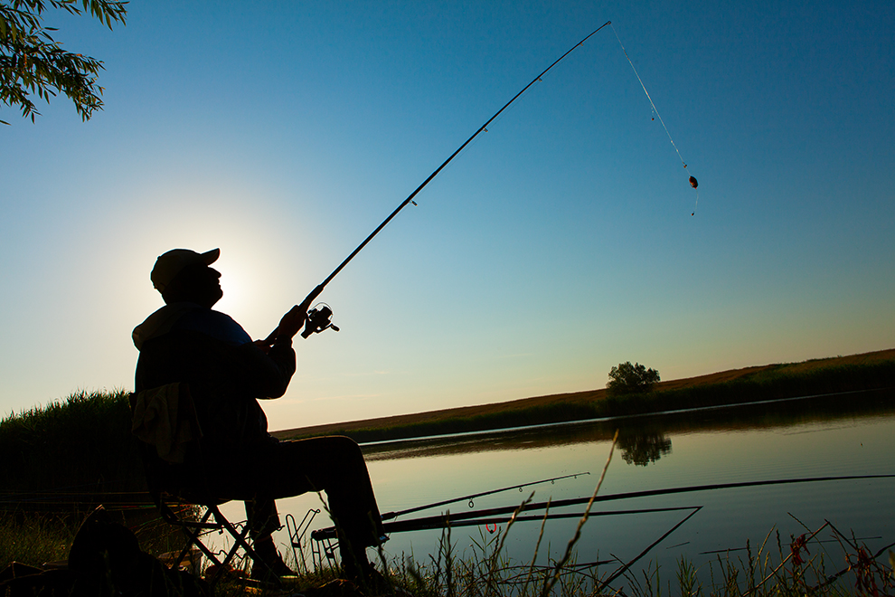 Young man fishing on a lake
